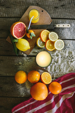Various bright whole and cut grapefruit and lemon on a table
