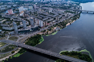 Residential district in a large metropolis with road junctions and houses near Dnepr river in Kiev, Ukraine. Aerial view. From above.