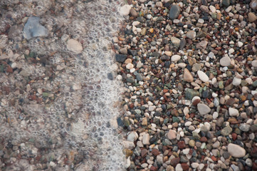 Sea coast.Wet pebble and wave