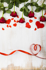 Red roses and ribbon in the shape of heart