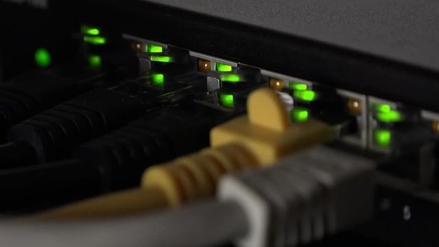 Network equipment with blinking LEDs as detailed 4K footage (close-up)