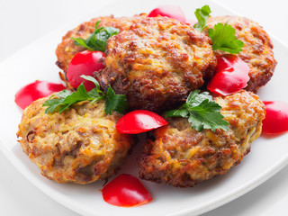 Beef cutlets with greens and vegetables on the plate