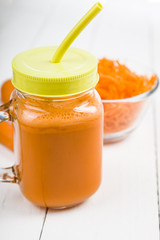 Carrot juice on a wooden table