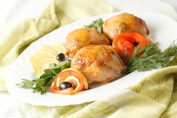 Roll chicken with greens and vegetables on the plate