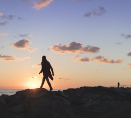 Woman on the rocks at sea