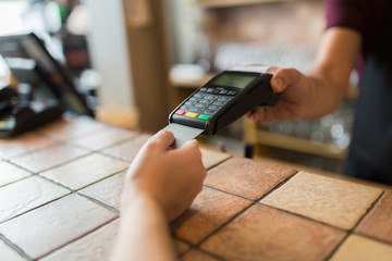 hands with payment terminal and credit card