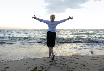 business woman on a sea beach