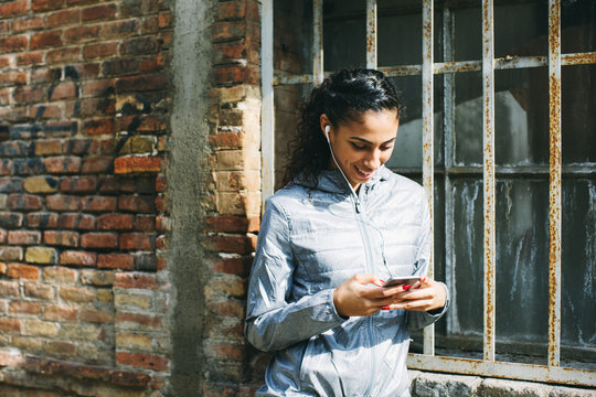 Portrait Of A Muslim Woman Using Her Phone On The Street.