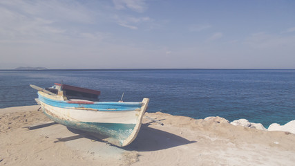 Fototapeta na wymiar Fishing boat on the shore of Aegean sea