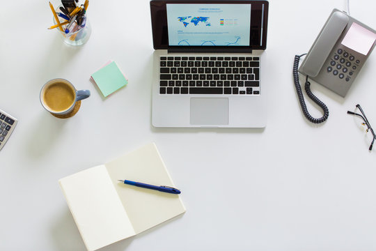 Laptop, Phone And Other Office Stuff On Table