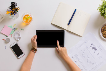 hands with tablet pc and notebook at office table