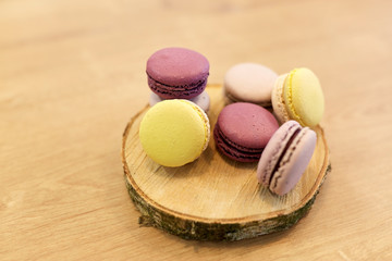 different macarons on wooden stand