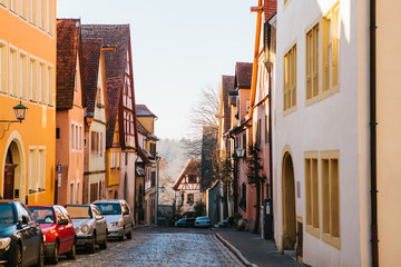 View of a beautiful street with traditional German houses in Rothenburg ob der Tauber in Germany. European city.