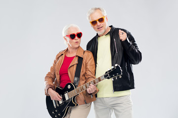 senior couple in sunglasses with electric guitar