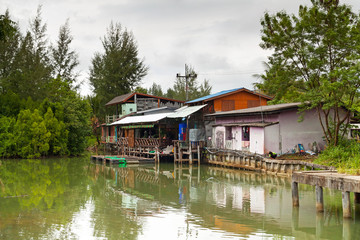 Fototapeta na wymiar Small village house at the river in Thailand