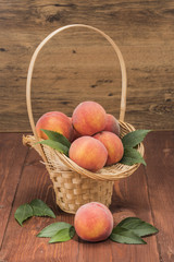 Peaches fresh new crop with leaves with juice on the table
