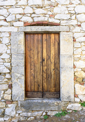old wooden door on stone wall