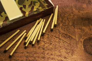 Boxes and matches on a dark brown wooden background