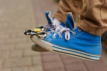 Fidget spinner on the toecap of a sneaker