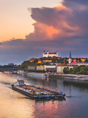 Fototapeta na wymiar Cityscape of Bratislava, Slovakia at Sunset as Seen from a Bridge over Danube River towards Btatislava Castle