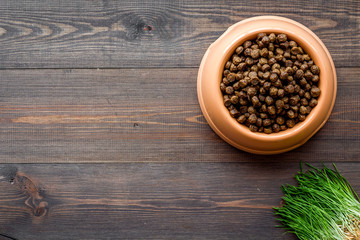 dry pet - dog food in bowl on wooden background top view mock up