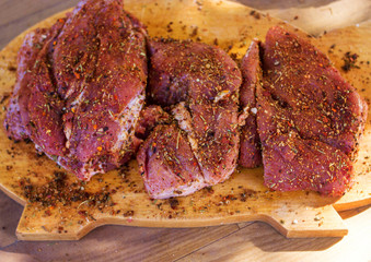 Obraz premium Raw meat with seasoning on the tree