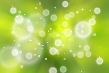 Artistic blurred yellow green colored circle bokeh pattern background.