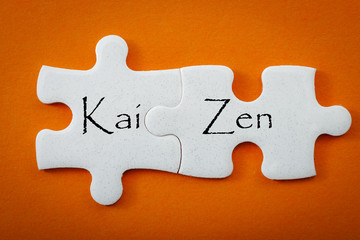 Business concept and interconnected puzzle pieces that put the words “kai” meaning 