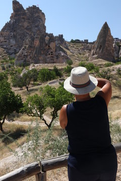 An English lady tourist taking pictures of the amazing landscape in Cappadocia, goreme in turkey,2017