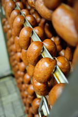 mouthwatering smoked sausages on the background of a meat factory or butcher shop