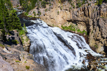 Fototapeta na wymiar Mountain waterfall. Silky smooth flowing water. Yellowstone National Park, USA