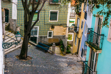 Street and cobblestone floor in the old neighborhood of Alfama, Lisbon, capital of Portugal
