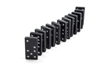 black dominoes in a row isolated on a white background, selective focus and narrow depth of field