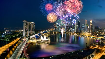 Tuinposter Aerial view of Fireworks celebration over Marina bay in Singapore. New year day 2018 or National day celebration at Singapore. Asia © ake1150