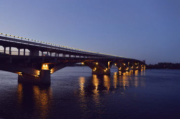 Kyiv. Ukraine. Metro Bridge over Dnieper River at dusk. Toned image.