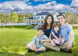 Fototapeta premium Happy Young Family With Children Outdoors In Front of Beautiful Custom Home.