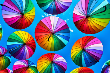 Rainbow umbrella on sky background. Many colorful umbrellas. umbrella street decoration