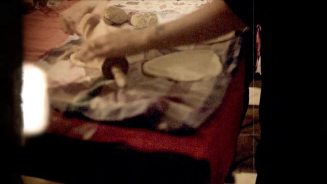 Fake 8mm amateur film: a little girl and her mother cooking panzerotti (a savory turnover which resembles a small calzone, both in shape and in the dough used for its preparation).
