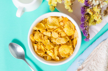 Corn flakes in a bowl with spoon for eating in the morning,breakfast or meal