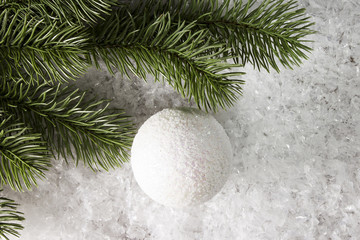 Branch of spruce with decoration in the snow