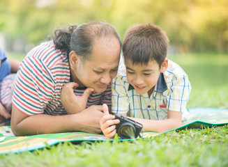 Single father and son taking camera together with happy smile