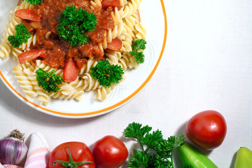 Pasta fusilli with parsley and Tomato Sauce on white Wooden Background