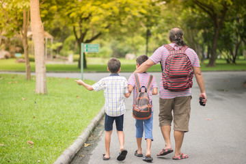Fototapeta premium Father and sons in the park