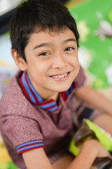 Portrait of smiling little asian boy close up