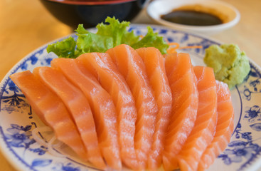 salmon fish with wasabi and sauce on table wood in restaurant