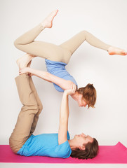 lifestyle, sport  and people concept: Young couple in yoga pose