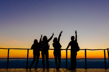 Fototapeta na wymiar silhouette travel group we looking twilight or sunset, beautiful twilight colorful man and women happy freedom life