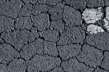 Detailed macro cracked tarmac, road surface.