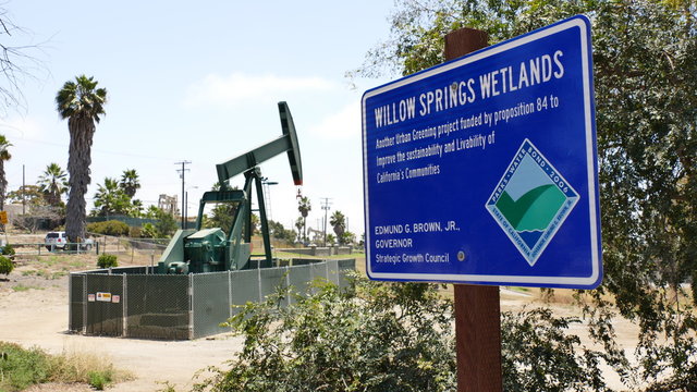 Oil wells pumping next t a wetlands preserve in Long Beach California, May of 2017