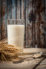 Fresh dairy products and wheat on rustic wooden background. Organic farming dairy concept
